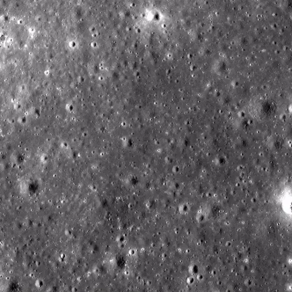 Cratered moonscape from orbit, then a huge crater with white rays around it.