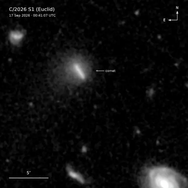 White streak moving from upper left to lower right with tiny, fuzzy background galaxies.