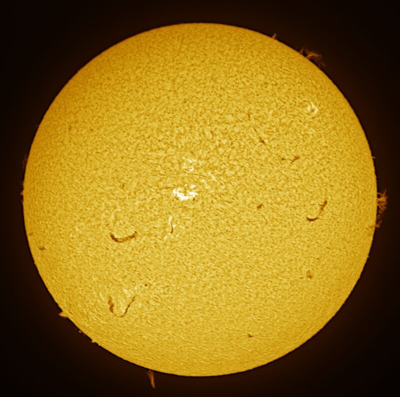 The sun, seen as a large yellow sphere with a mottled surface.