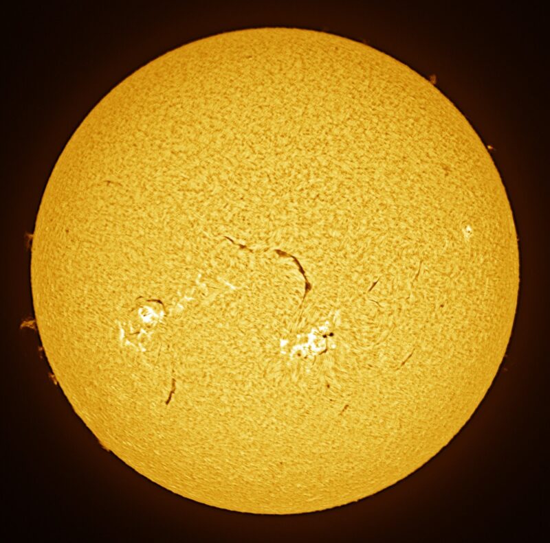 The sun, seen as a large yellow sphere with a mottled surface.