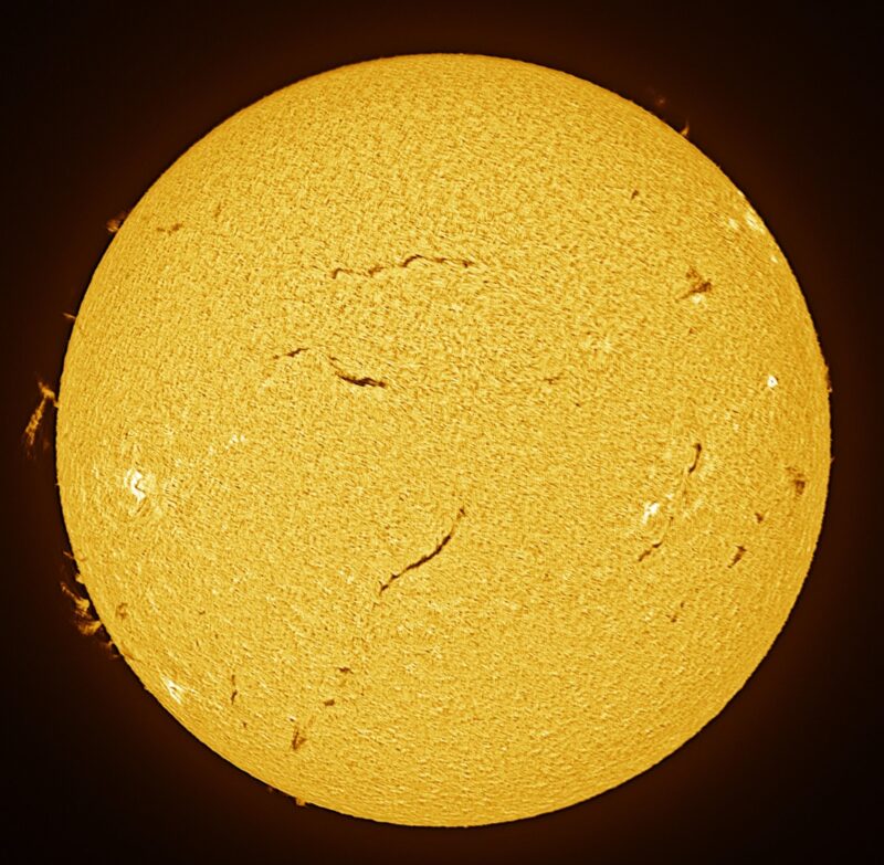 The sun, seen as a large yellow sphere with a mottled surface.