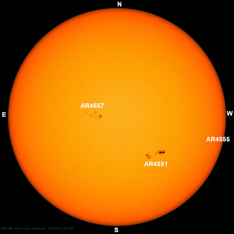 The sun in visible light, a yellow disk with a few small dark sunspots, each labeled with its active region number.