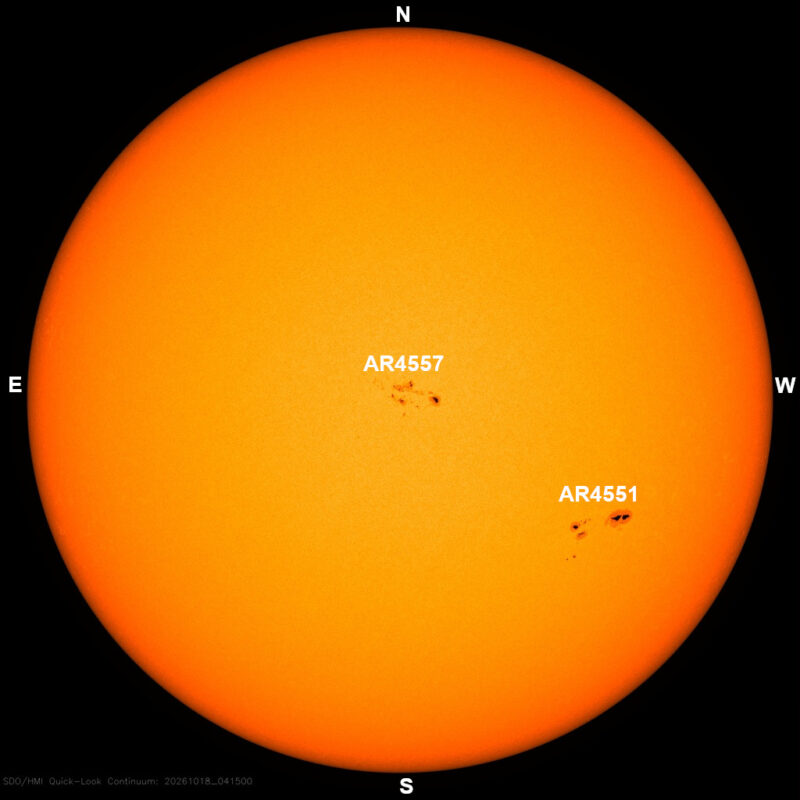 The sun in visible light, a yellow disk with a few small dark sunspots, each labeled with its active region number.