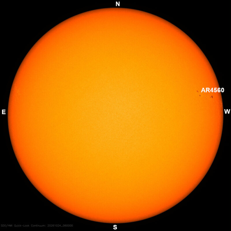 The sun in visible light, a yellow disk with a few small dark sunspots, each labeled with its active region number.
