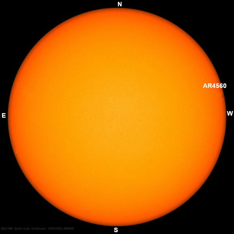 The sun in visible light, a yellow disk with a few small dark sunspots, each labeled with its active region number.