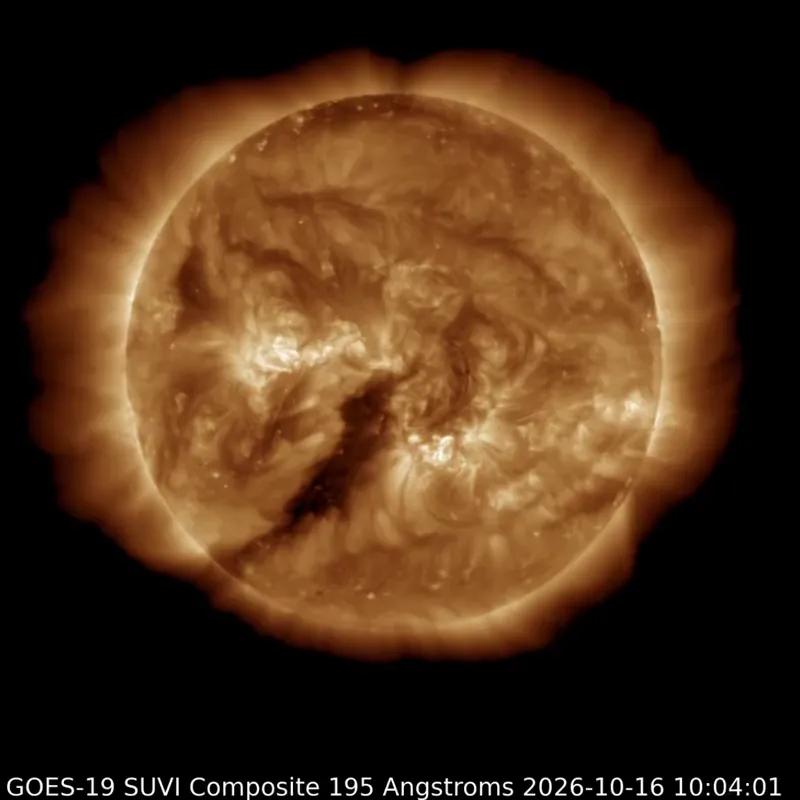 The sun is glowing gold in extreme ultraviolet light, with a large dark coronal hole facing toward Earth.
