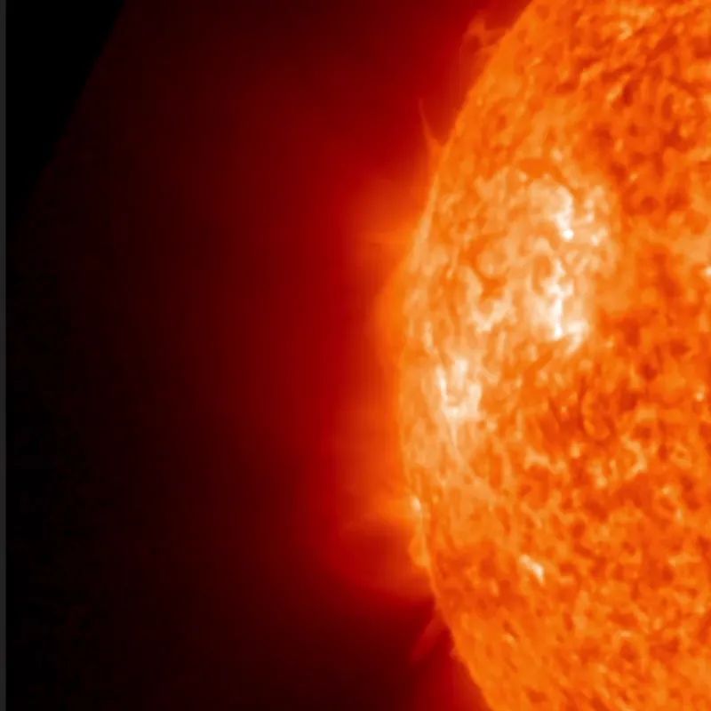 A long filament lifting off the sun's edge and erupting into a large prominence, seen in orange-red extreme ultraviolet light.