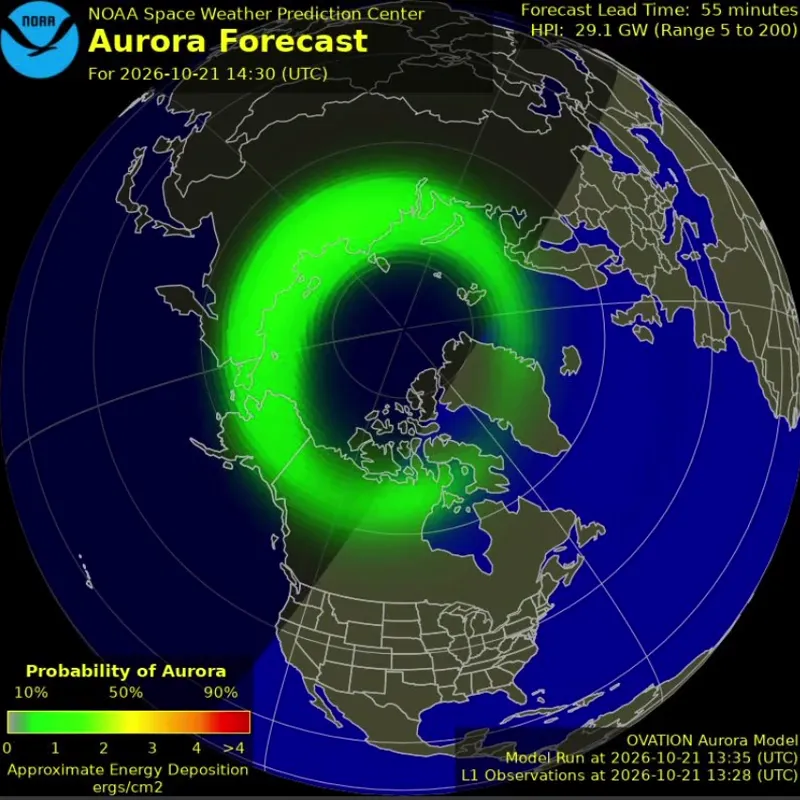 Map of the Northern Hemisphere with a green auroral oval over Alaska and Canada, part of it in daytime shading.