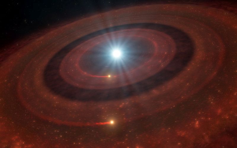 Solar system's future: Bright white light at center with 2 wide, concentric fuzzy red bands around it.