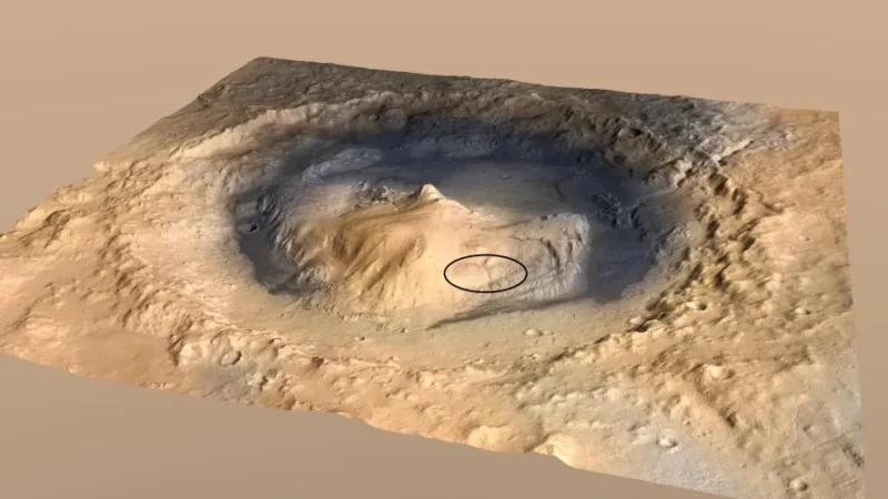 View looking down at a mountainous region with an oval circled near the base.