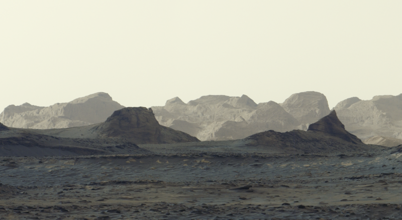 Martian dawn: Creamy, solid sky with light on distant cliffs and closer cliffs darker.