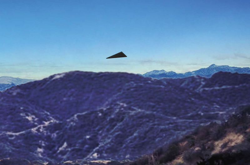 Pentagon UAP files: Black triangular object over mountains.